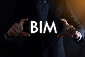 Business, Technology, Internet and network concept. Young businessman working on a virtual screen of the future and sees the inscription:BIM.
